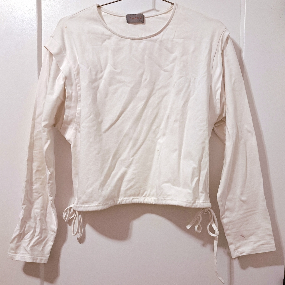 White woman's shirt with drawstring adjustable cute ties on the bottom.
